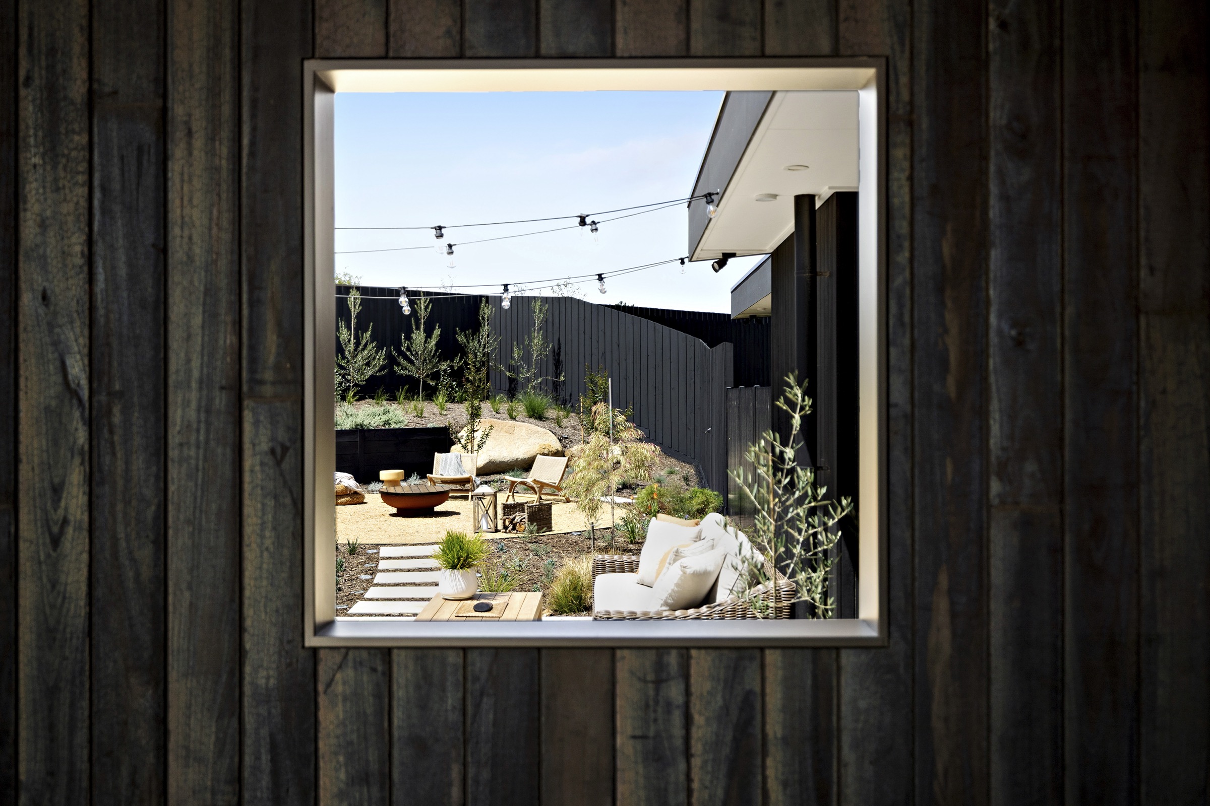 Framed picture window looking into the firepit courtyard at Waterfall Gully Road